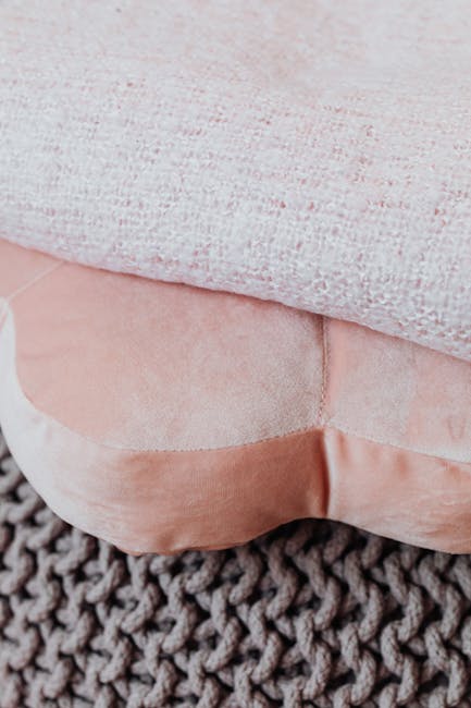 Close-up of headphones on a cozy textured blanket.