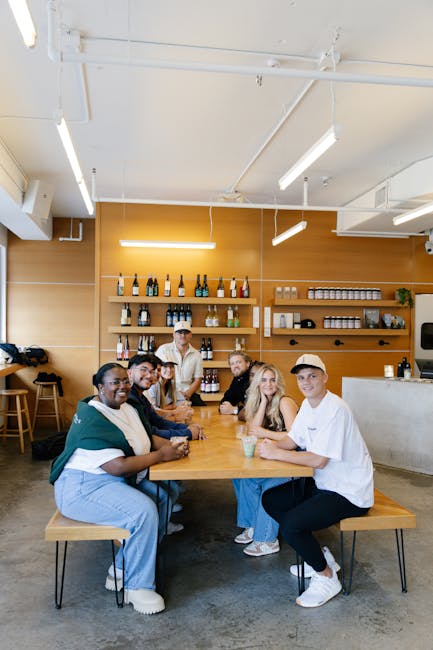 Diverse group of people smiling and looking relaxed in a bright, modern space.